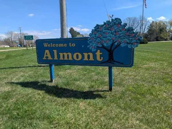 Welcome to Almont sign with apple tree icon